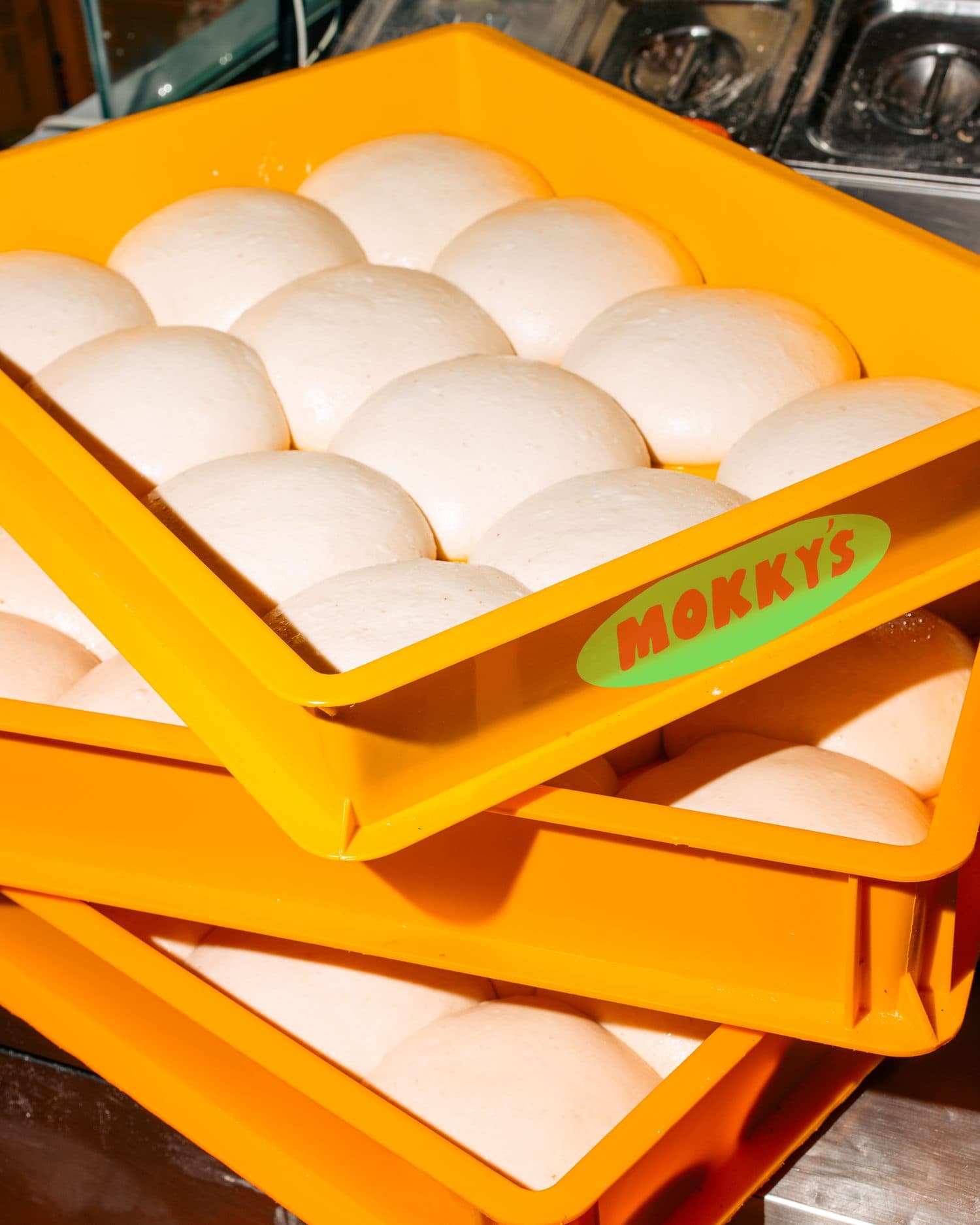 Crates of fresh dough balls, proofing