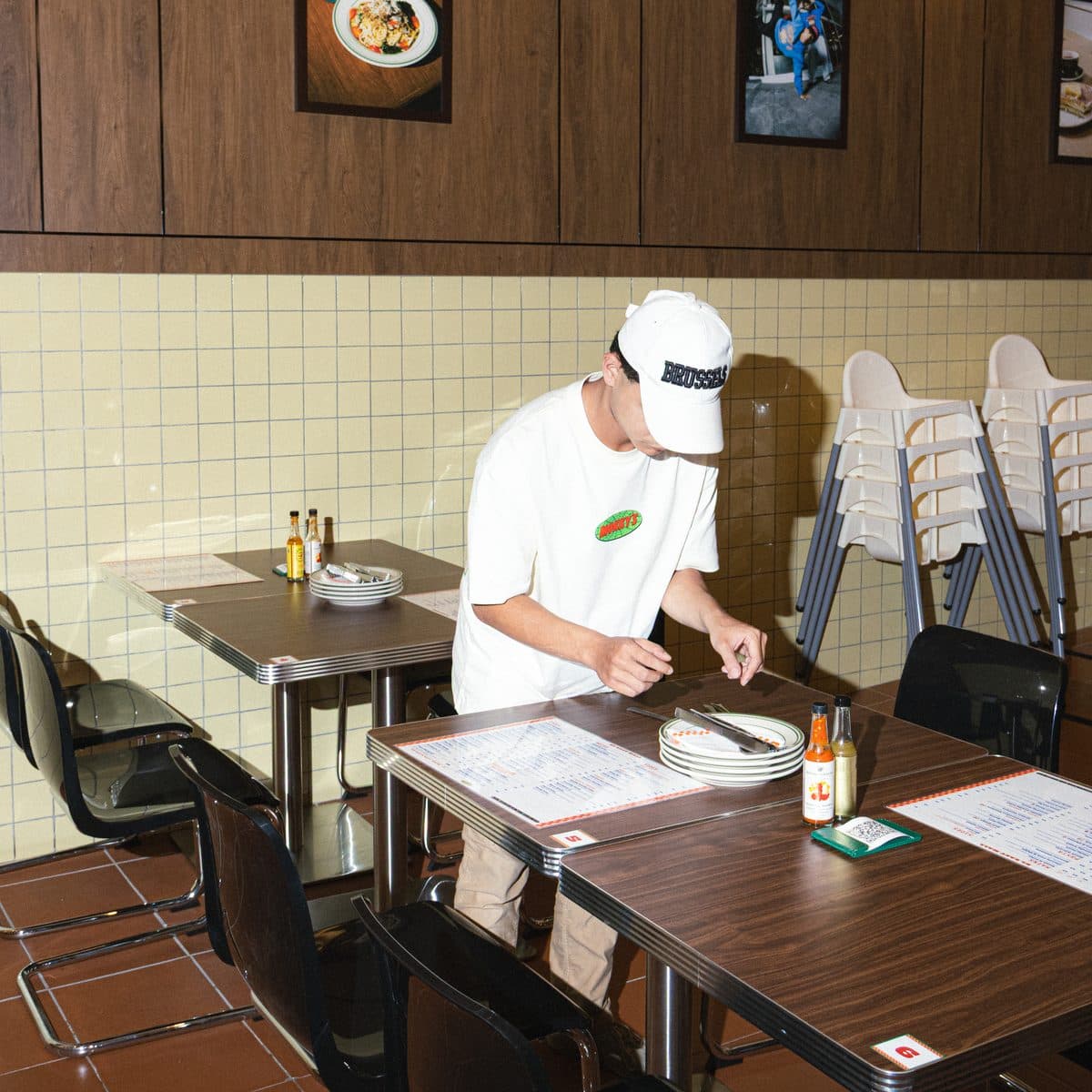A crew member setting tables inside Mokky's KL East Mall