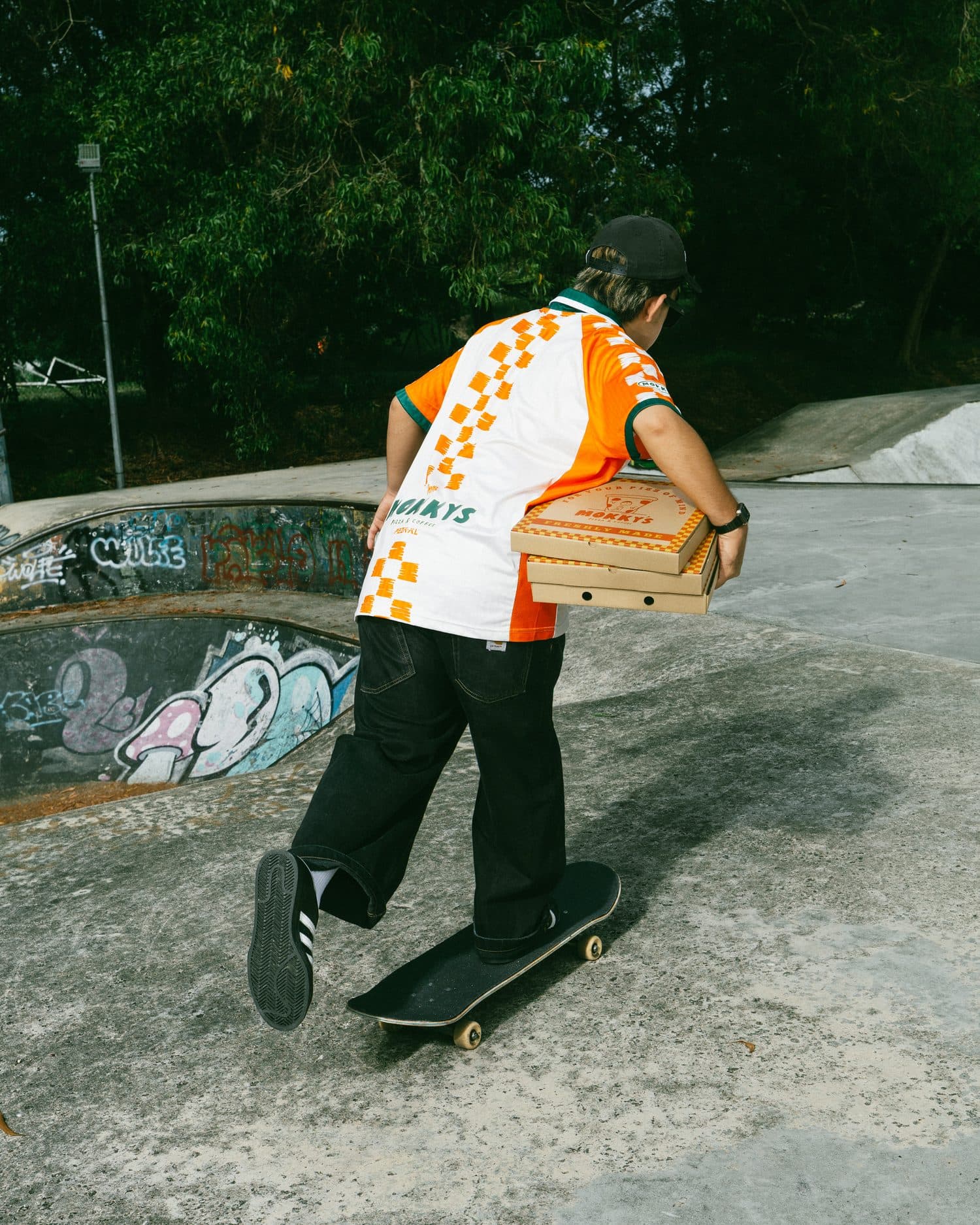 Skating off with a stack of Mokky's pizza boxes