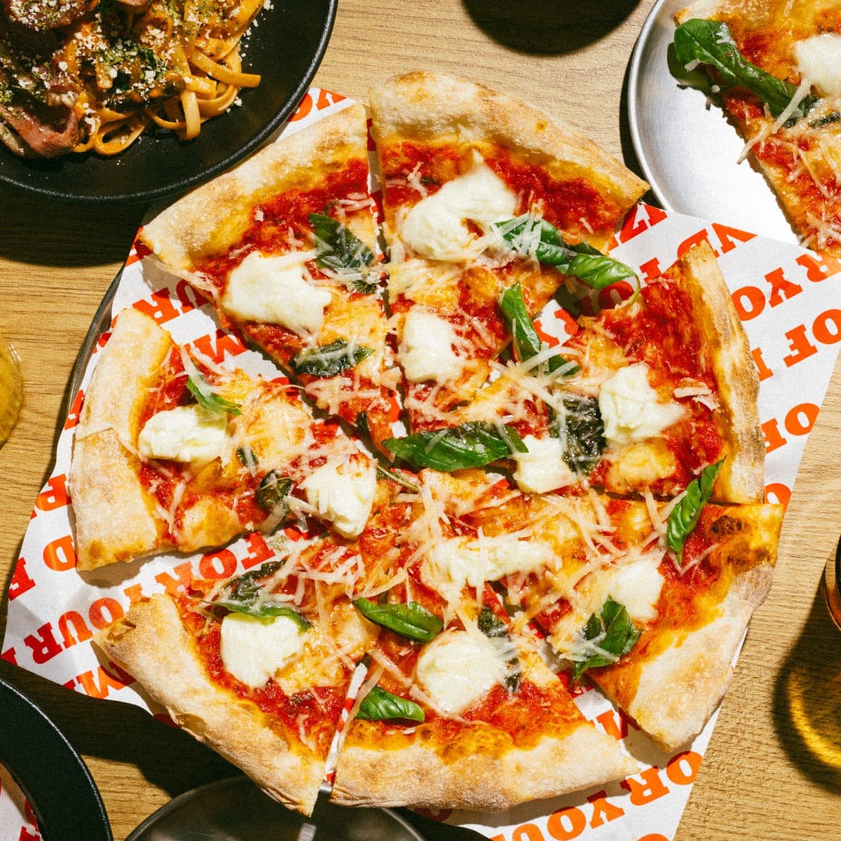 A fresh Mokky's pizza topped with basil, from above